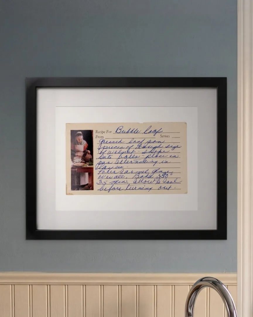 The Bubble Loaf recipe card, printed, matted and framed on a kitchen wall above the sink.
