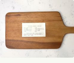 A recipe card laid on a wooden board to photograph.